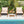 3 Pieces Patio Wicker Furniture Set with 2-Tier Side Table and Cushioned Armchairs-Natural