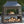 Four Seasons Courtyard Wood Burning Fireplace with Log Rack and Tool, Black/Gold