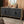 Black Carved Symmetrical Design Door And Wood Coloured Frame TV Stand