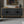 Black Carved Symmetrical Design Door And Wood Coloured Frame TV Stand