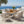 Outdoor 7-Piece Dining Set - Rectangular Teak Wood Table + 6 Wicker Chairs with Cushions