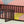 Twin Size Floor Bed Frame With Fence And Door - Walnut
